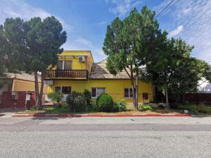 a yellow house on the side of a street at Apartman LALI in Veľký Meder