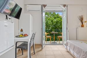 a bedroom with a bed and a table with a plate of fruit on the table at SALV3R Hotel in Athens