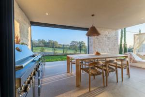 a kitchen with a wooden table and a large window at Sella Marron in Selina