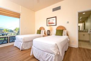two beds in a room with a balcony at Kapalua Bay Villas 2 Free Rental Cars KBM Resorts Large Master Suite 2 Units 3 Bedrooms ML-1528 in Honokahua