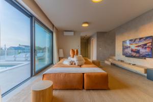 a bedroom with a large bed and a large window at Sella Marron in Selina +42 photos