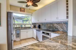a kitchen with white cabinets and a ceiling fan at Kapalua Bay Villas 2 Free Rental Cars KBM Resorts Premium Bay Villa 2 Units 3 Bedrooms ML-1604 in Honokahua