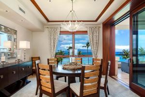 a dining room with a table and chairs and a large window at Montage Kapalua Bay 2 Free Rental Cars KBM Resorts Beautiful Villa At Montage Kapalua Bay 2 Units 6 Bedrooms ML-1507 in Honokahua