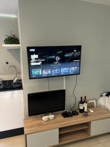 a flat screen tv hanging on a wall at Home Away From Home 6 minutes away from beach in Cape Town