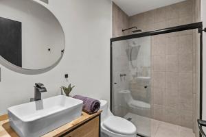 un bagno con lavandino, WC e doccia di Industrial Loft King Bed and 2 Office Spaces a Durango Altre 31 foto
