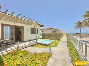 a house with a patio and a swimming pool at Beach-Home Pontal de Maceió in Fortim