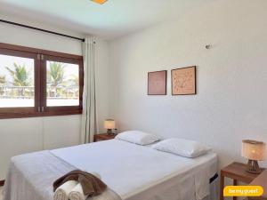 a bedroom with a white bed and a window at Beach-Home Pontal de Maceió in Fortim +73 photos