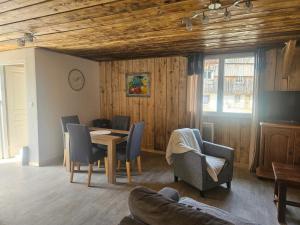a living room with a table and chairs at Le ptit clos in Les Combes +1 photo