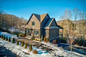 a house with a black roof in the snow at Maynard V at Elk Creek in Banner Elk