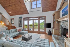 a living room with a couch and a fireplace at Peaceful View in Linville Falls