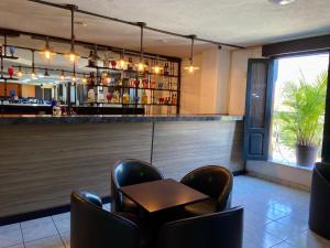 a bar with chairs and a table in a restaurant at Hotel María del Carmen in Jalpan de Serra