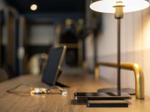 a lamp sitting on top of a wooden table at Hotel Mercure Wien City in Vienna +44 photos