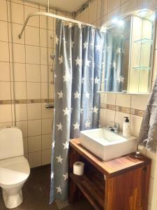 a bathroom with a sink and a shower curtain with stars at Edullinen kaksio in Töysä