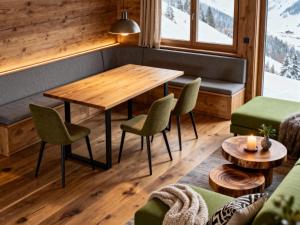约赫贝格Haus Tauernblick Top 2 und 3 und 4的配有木桌椅的餐厅