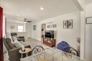 a living room with a couch and a tv at 1 Mi to Truman Library Apt with Large Yard! in Sugar Creek