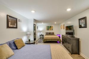 a living room with a bed and a couch at 1 Mi to Truman Library Apt with Large Yard! in Sugar Creek