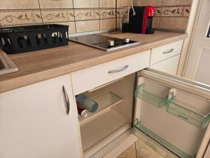 a kitchen with white cabinets and a sink at Apartmani Vlaovic in Herceg-Novi