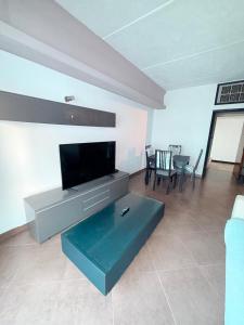 a living room with a flat screen tv and a couch at 2 Bedroom City Centre Gibraltar in Gibraltar