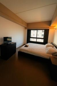 a bedroom with a large bed and a window at 2 Bedroom City Centre Gibraltar in Gibraltar