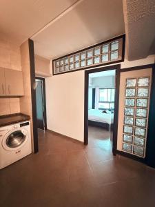 a kitchen with a washing machine in a room at 2 Bedroom City Centre Gibraltar in Gibraltar