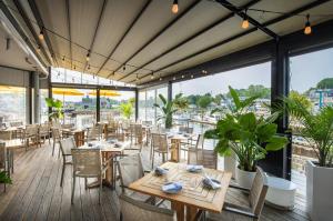 a restaurant with tables and chairs and windows at The Boathouse in Kennebunkport