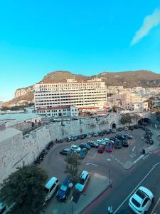 a large building with cars parked in a parking lot at 2 Bedroom City Centre Gibraltar in Gibraltar +20 photos