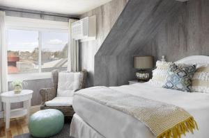 a bedroom with a large bed and a window at The Boathouse in Kennebunkport
