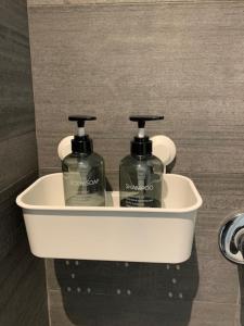 two bottles of soap in a bathroom sink at Ripalta House in San Donato Milanese +26 photos