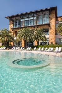 a large swimming pool in front of a building at Hotel Sofitel La Reserva Cardales in Campana
