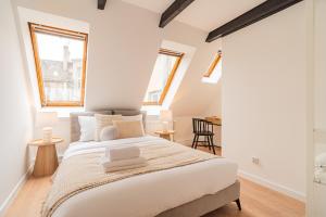 sypialnia z dużym białym łóżkiem i 2 oknami w obiekcie Raciborska Old Town w mieście Gliwice