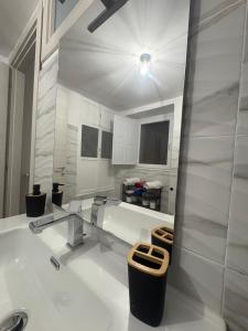 a white bathroom with a sink and a tub at Residenza Stella in Isernia