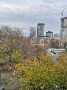a city skyline with tall buildings in the background at Воскресенская 1 Набережная 2 кв in Dnipro