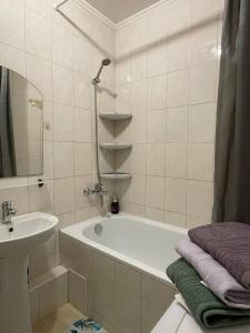 a white bathroom with a tub and a sink at Воскресенская 1 Набережная 2 кв in Dnipro +18 photos