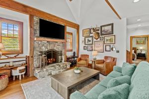 a living room with a couch and a fireplace at Creekside Hideaway at The Farm in Banner Elk