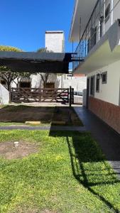 a building with a grassy yard next to a building at Doña Aida in Mina Clavero +5 photos