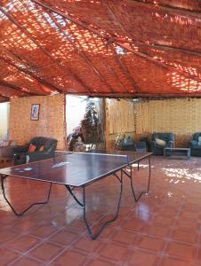a ping pong table in the middle of a room at Lodge Gabriela Mistral in Pisco Elqui