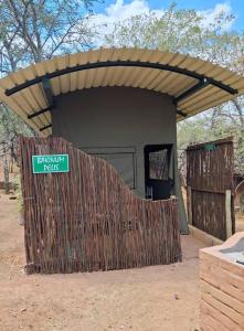 a small building with a sign in front of it at Pumba's Den Kranspoort in Winterkamp