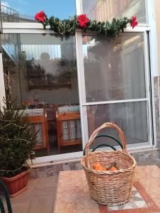 a basket of oranges sitting on a table in front of a window at La casetta di Jasmine in Salerno