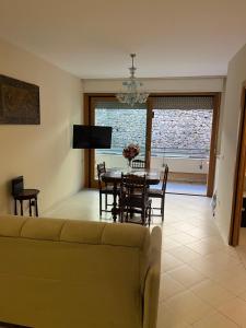 a living room with a couch and a table and chairs at Conte di Cavour in Rocca di Papa