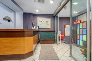 a lobby with a bar in a building at SALV3R Hotel in Athens