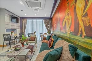 a living room with a couch and a painting on the wall at SALV3R Hotel in Athens