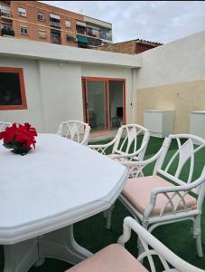 a white table and chairs on a balcony at La Casita de Beni Valencia in Valencia +2 photos
