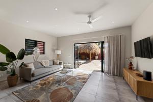 a living room with a couch and a table at Casa Carpe Diem with private pool, Mambo Beach in Willemstad