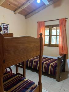 a bedroom with two bunk beds and a window at Reserva Ichacuna in Los Hornillos +13 photos