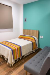 a room with two beds and a flat screen tv at Condominio Alegre Amanecer in Santa Cruz Huatulco +11 photos