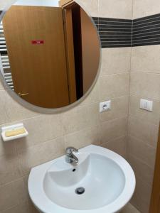 a bathroom with a sink and a mirror at Conte di Cavour in Rocca di Papa +6 photos