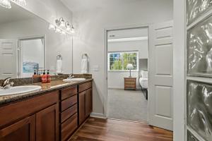 a bathroom with two sinks and a large mirror at Obertal Inn in Leavenworth +145 photos