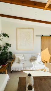 a living room with a white bed and a table at Villa Salinas Beach Home Natural Park in La Manga del Mar Menor