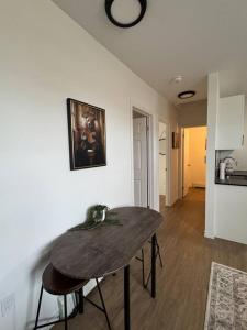 a wooden table in a room with a kitchen at Affordable Elegance Modern 2BR Getaway in London +6 photos