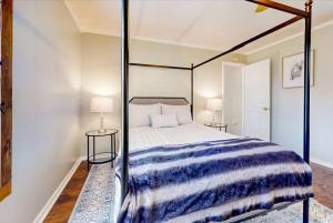 a bedroom with a canopy bed and two tables at SLAUGHTER in Austin